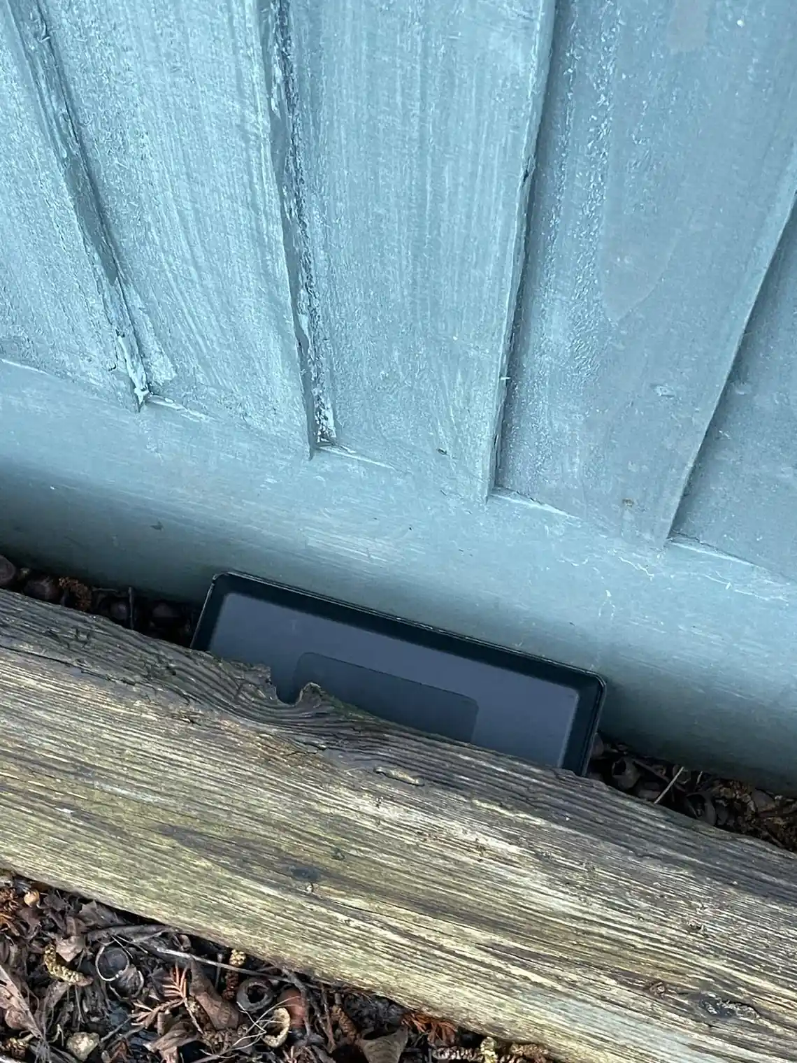 Tamper-resistant rodent bait station installed for safe mouse control Tamper-resistant rodent bait station installed for safe mouse control